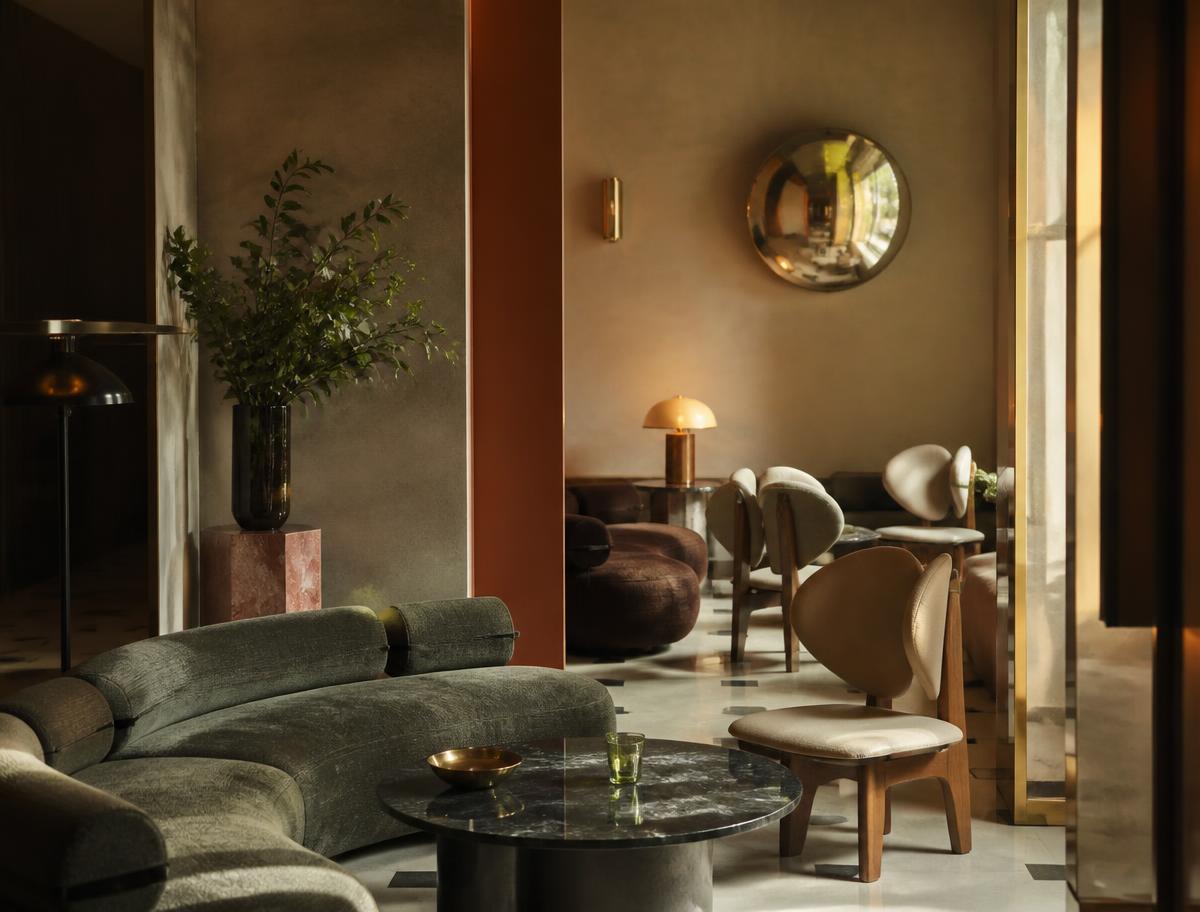 Boutique hotel lounge with sculptural custom furniture and brass detailing