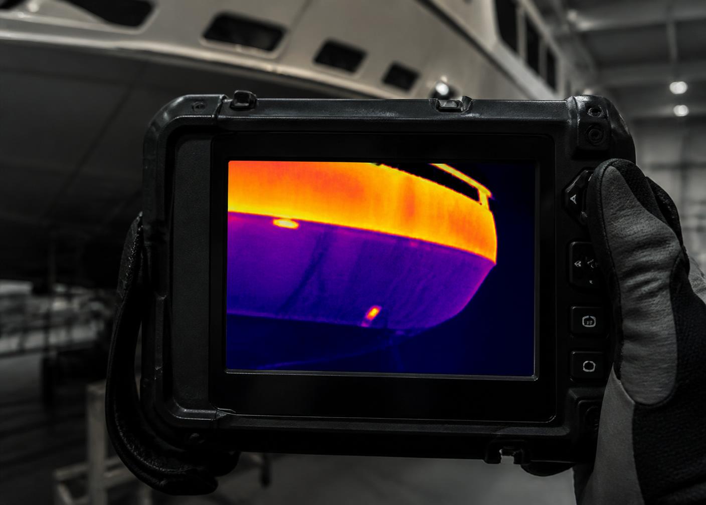 Thermal imaging camera showing a heat map of a yacht hull